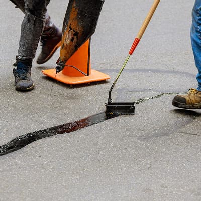 Asphalt crack filling on a residential driveway