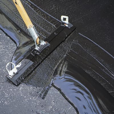 Seal coating application on asphalt pavement